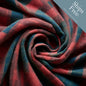 Rustic Strength, photographic image of red-dominant plaid flannel fabric bunched into a spiral with badge that reads, "Ships Free* When it is the only item in your cart"