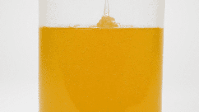 Rustic Strength, gif depicting castile soap being poured from a jug into a jar. it is thick and golden in color.