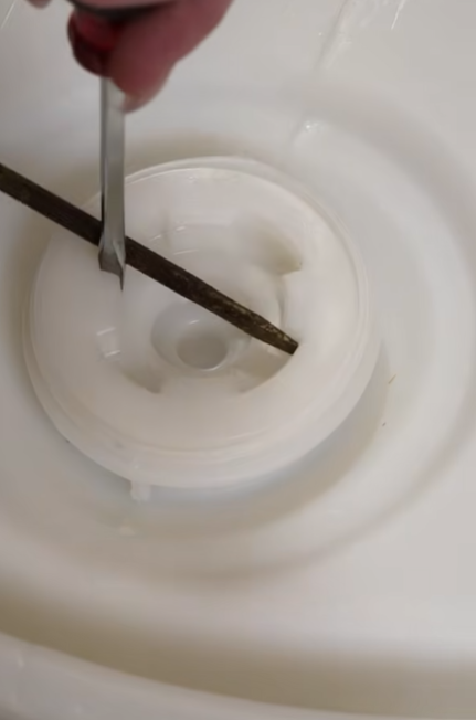 Rustic Strength, Still from video depicting How to Open a Drum using 2 Screw Drivers.