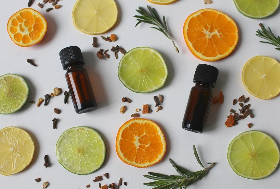 Rustic Strength, glass bottles on a background with citrus slices, herbs and rosemary sprigs